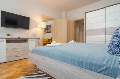 a bedroom with a large bed and a tv at Spacious Sofia Condo - Philadelphia LOVE in Sofia