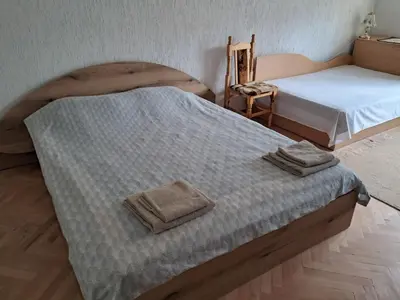 a bedroom with two beds with towels on it at Katerci in Trigrad