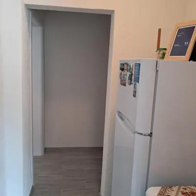 a kitchen with a white refrigerator in a room at Katerci in Trigrad