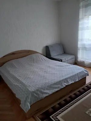 a bed and a chair in a bedroom at Katerci in Trigrad