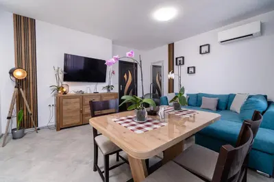 a living room with a blue couch and a table at 1-Bedroom apartment with Free Private parking in Plovdiv