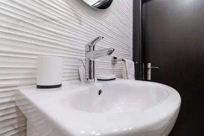 a white sink with a faucet in a bathroom at 1-Bedroom apartment with Free Private parking in Plovdiv