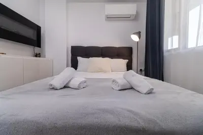 a bedroom with a bed with two white pillows at 1-Bedroom apartment with Free Private parking in Plovdiv