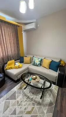 a living room with a couch and a glass table at John Apartment 2 in Blagoevgrad