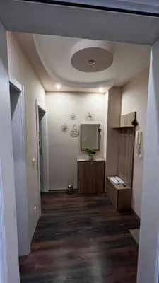 a hallway with a room with a tv on the wall at John Apartment 2 in Blagoevgrad