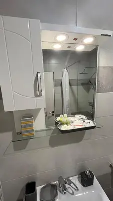 a kitchen counter with a sink and a mirror at John Apartment 2 in Blagoevgrad