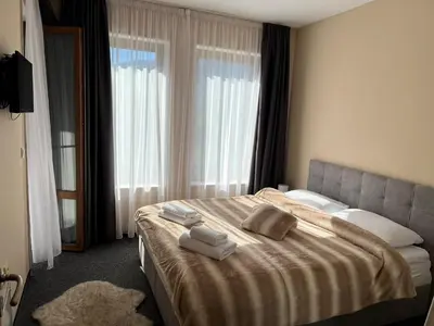 a hotel room with a bed with towels on it at Boris’s Guest Apartment in Chepelare