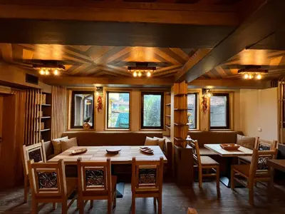 a dining room with a table and chairs at Китанова къща in Koprivshtitsa