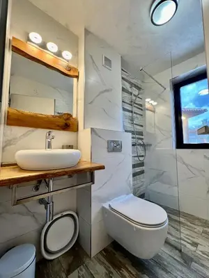 a bathroom with a sink and a toilet and a shower at Китанова къща in Koprivshtitsa