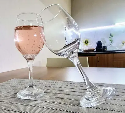 two glasses of wine sitting on a table at Апартамент А101 хотел Снежанка in Pamporovo