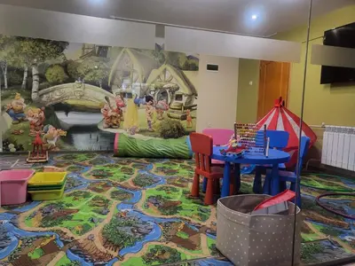 a room with a table and chairs and a mural at Апартамент А101 хотел Снежанка in Pamporovo