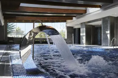 a water fountain in the middle of a building at Wonderful ski resort apartment in Bansko