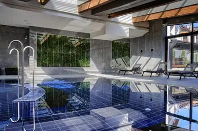 a swimming pool with blue tiles in a house at Wonderful ski resort apartment in Bansko