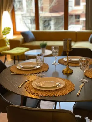 a table with plates and wine glasses on it at Wonderful ski resort apartment in Bansko