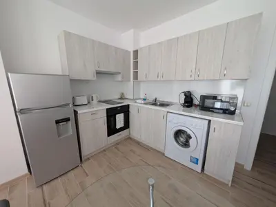 a kitchen with a refrigerator and a washer and dryer at Апартамент - Студио Престиж 2 in Hisarya