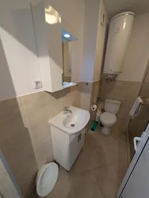 a bathroom with a sink and a toilet at Апартамент - Студио Престиж 2 in Hisarya