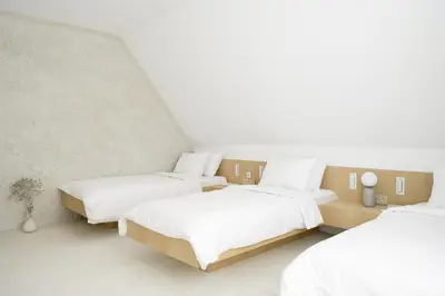 two beds in a room with white walls at Hotel Hello Plovdiv - Free Parking and Pet Friendly in Plovdiv
