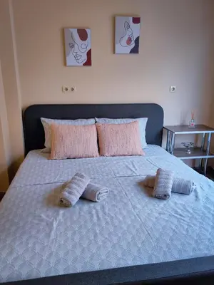 a bed with two pillows on top of it at The View Apartment in Plovdiv