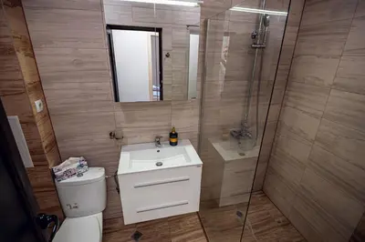 a bathroom with a toilet and a sink and a shower at ДиНати in Plovdiv