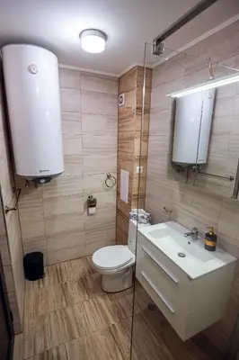a bathroom with a toilet and a sink and a mirror at ДиНати in Plovdiv