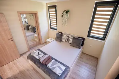 a small room with a bed and a mirror at ДиНати in Plovdiv