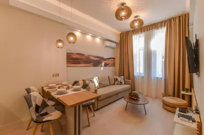 a living room with a couch and a table at Elegant 1BD Stay on Ekzarh Yosif, Sofia by Flat Mаnager in Sofia
