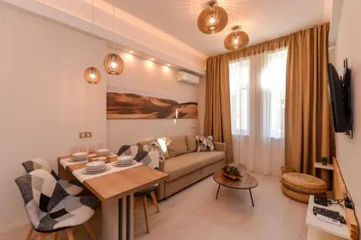 a living room with a couch and a table at Elegant 1BD Stay on Ekzarh Yosif, Sofia by Flat Mаnager in Sofia