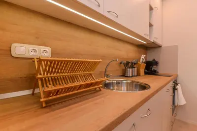 a kitchen with a sink and a wooden counter top at Elegant 1BD Stay on Ekzarh Yosif, Sofia by Flat Mаnager in Sofia