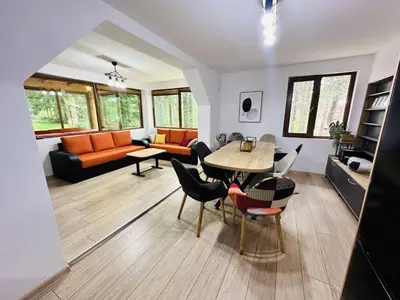 a living room with a table and chairs at Вила Данели in Tsigov Chark