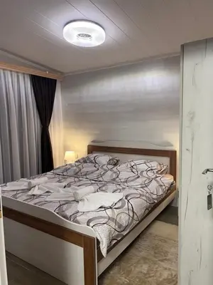 a bedroom with a bed in a room at SAFI FOREST village in Dospat