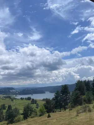 a view of a lake in a field with a cloudy sky at SAFI FOREST village in Dospat