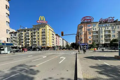 an empty city street with a traffic light and buildings at Apartment in the Top center next to NDK in Sofia