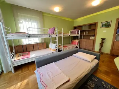 a room with two bunk beds and a couch at Mumbai Spacious 150 Sq M 2BDR near Vitosha BLVD and NDK in Sofia