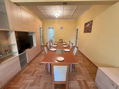a long dining room with a long table and chairs at Mumbai Spacious 150 Sq M 2BDR near Vitosha BLVD and NDK in Sofia