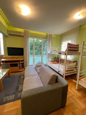 a living room with a couch and bunk beds at Mumbai Spacious 150 Sq M 2BDR near Vitosha BLVD and NDK in Sofia