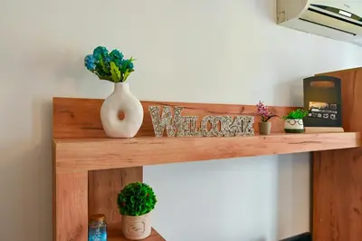 a wooden shelf with plants and a vase on it at Studio 19 in Sofia