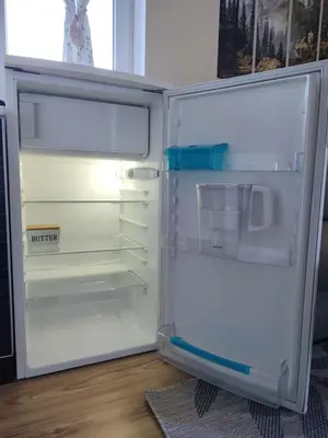 an empty refrigerator with its door open in a room at apartment Serenity, Bansko in Bansko