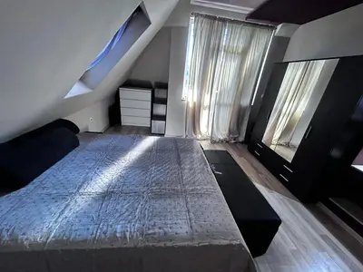 a bedroom with a large bed and a window at кристален въздух in Sofia