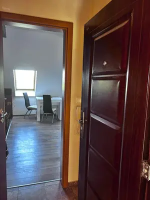 a door leading into a room with a table and chairs at кристален въздух in Sofia