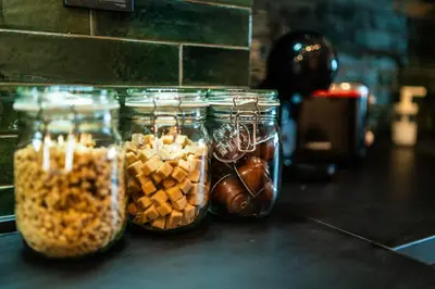 a group of glass jars filled with nuts and seeds at Home Library in Sofia