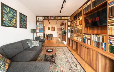 a living room with a couch and a book shelf at Home Library in Sofia