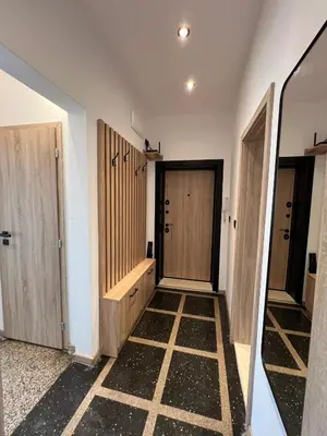 a hallway with wooden doors and a tiled floor at Home Library in Sofia