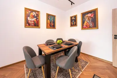 a dining room with a table and chairs at Home Library in Sofia
