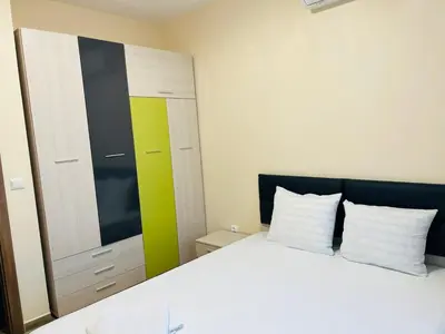 a bedroom with a white bed and a mirror at Cherry Apartment with 2 bedrooms in Sofia