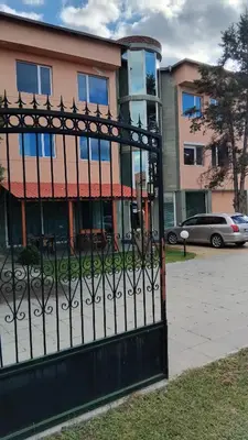 a black iron gate in front of a building at Интернационал in Kulata