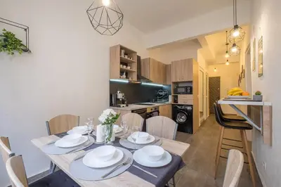 a dining room and kitchen with a table and chairs at Stay and Play - Foosball and Comfort in Sofia