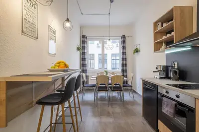 a kitchen and dining room with a table and chairs at Stay and Play - Foosball and Comfort in Sofia
