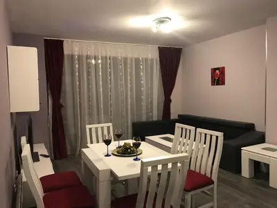 a room with a white table and chairs and a couch at Predela 1 Bansko Apartment in Bansko