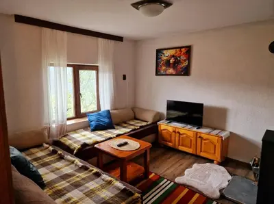 a living room with two couches and a tv at Вила Леска in Leska