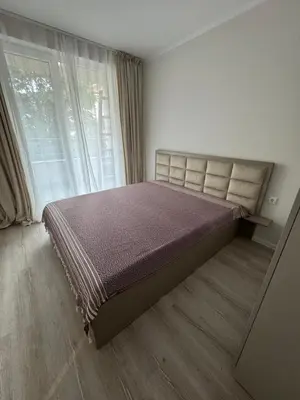 a bedroom with a bed and a large window at Lux City Apartment, free parking in Pazardzhik